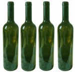 Four empty green wine bottles